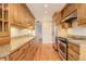 Modern kitchen featuring stainless steel appliances, wood cabinets, and granite countertops at 3127 And 3125 N Raleigh St, Denver, CO 80212