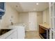 Laundry room with washer, dryer, utility sink, and tile floor at 3127 And 3125 N Raleigh St, Denver, CO 80212