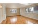 Bright living room with hardwood floors, large windows, and a built-in cabinet at 3127 And 3125 N Raleigh St, Denver, CO 80212