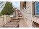 Side yard with a small building, pathway, garden bed, and well-maintained fence at 3127 And 3125 N Raleigh St, Denver, CO 80212
