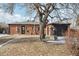 View of the backyard with a red brick house and detached garage plus a wishing well feature at 3630 N Saint Paul St, Denver, CO 80205