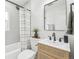 A full bathroom with a shower and a sink with wooden accents at 3630 N Saint Paul St, Denver, CO 80205