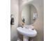Bathroom featuring pedestal sink, decorative mirror, and neutral wall color at 11709 Park South Ln, Parker, CO 80138