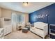 Neutral bedroom featuring a white crib, sitting chair, and a window with blinds at 11709 Park South Ln, Parker, CO 80138