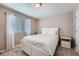 Bright bedroom featuring a white bed frame, a window with blinds, and neutral walls at 11709 Park South Ln, Parker, CO 80138