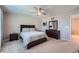 This bedroom features a ceiling fan, a bed with a headboard, and a dresser with a mirror at 11709 Park South Ln, Parker, CO 80138