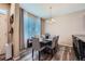 This dining room features a wooden table with gray chairs and a modern chandelier at 11709 Park South Ln, Parker, CO 80138