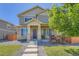 Charming two-story home featuring stone accents, a welcoming front porch, and professionally landscaped yard at 11709 Park South Ln, Parker, CO 80138