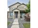 Charming two-story home with stone accents, covered porch, and manicured front yard at 11709 Park South Ln, Parker, CO 80138