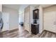 Hallway with dark wood floors, white doors, and a built-in cabinet with granite countertop at 11709 Park South Ln, Parker, CO 80138