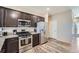 The kitchen boasts stainless steel appliances, granite countertops, and dark wood cabinets at 11709 Park South Ln, Parker, CO 80138