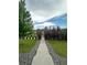 Beautifully landscaped walkway leading to a private backyard with lush greenery at 11709 Park South Ln, Parker, CO 80138