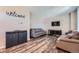 Open living space featuring modern floors, comfortable sofas, and a welcome sign at 11709 Park South Ln, Parker, CO 80138