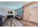 Living room featuring modern floors, a comfortable sofa, and neutral decor at 11709 Park South Ln, Parker, CO 80138