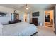 Spacious main bedroom featuring a ceiling fan, TV, a walk-in closet, and ensuite bathroom at 11709 Park South Ln, Parker, CO 80138
