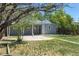 Backyard view showcasing the covered patio, landscaping, and ample green space at 967 Victor St, Aurora, CO 80011