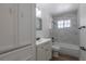 Updated bathroom featuring a shower-tub combo and single sink vanity with plenty of storage at 967 Victor St, Aurora, CO 80011