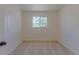 Bright bedroom area with neutral carpeting and light from large window at 967 Victor St, Aurora, CO 80011