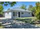 A quaint one story house with a well-maintained lawn and neutral-colored exterior at 967 Victor St, Aurora, CO 80011