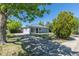 Charming single-story home features mature trees, a spacious front yard, and a concrete driveway at 967 Victor St, Aurora, CO 80011