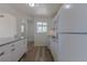 Bright kitchen featuring white cabinets, granite countertops, and modern appliances at 967 Victor St, Aurora, CO 80011