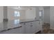 Bright kitchen featuring white cabinets, granite countertops, and modern appliances at 967 Victor St, Aurora, CO 80011