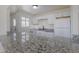 Bright kitchen featuring white cabinets, granite countertops, and modern appliances at 967 Victor St, Aurora, CO 80011