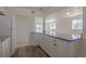Bright kitchen with granite countertops and views of the living area and stainless-steel refrigerator at 967 Victor St, Aurora, CO 80011