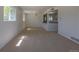 Spacious living room area with neutral carpeting and bright, open feel to the kitchen area at 967 Victor St, Aurora, CO 80011