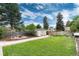 Spacious backyard with a storage shed, fire pit, and mature trees at 3175 S Pennsylvania St, Englewood, CO 80113