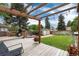Inviting backyard deck with a pergola, grill, and landscaped yard at 3175 S Pennsylvania St, Englewood, CO 80113