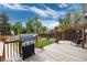 Outdoor grill on wooden deck, pergola, and lush green yard at 3175 S Pennsylvania St, Englewood, CO 80113