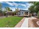 Backyard features a wooden deck, pergola, grassy area, and shed at 3175 S Pennsylvania St, Englewood, CO 80113