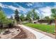 Landscaped backyard features a fire pit, grassy area, and convenient storage shed at 3175 S Pennsylvania St, Englewood, CO 80113