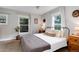 Cozy bedroom with neutral tones, two windows, and ceiling fan at 3175 S Pennsylvania St, Englewood, CO 80113