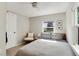 Bright bedroom featuring a neutral palette, window, and a ceiling fan at 3175 S Pennsylvania St, Englewood, CO 80113