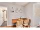 Cozy dining area with seating for four, decorative mirrors, and doorway to the bathroom at 3175 S Pennsylvania St, Englewood, CO 80113