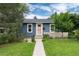 Charming blue single-story home with well-maintained lawn, walkway, and inviting, peach-colored front door at 3175 S Pennsylvania St, Englewood, CO 80113