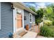 Cozy front porch with charming peach-colored door and view of small outdoor seating area at 3175 S Pennsylvania St, Englewood, CO 80113