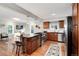 Modern kitchen with stainless steel appliances, gas range, and island with bar seating, flowing into living area at 3175 S Pennsylvania St, Englewood, CO 80113