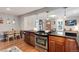 Open concept kitchen with stainless steel stove, granite countertops, and seating area at 3175 S Pennsylvania St, Englewood, CO 80113