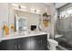 Modern bathroom with double sinks, large mirror, and tiled walk-in shower offering a luxurious experience at 3814 Zenobia St, Denver, CO 80212