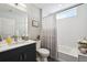 Bright bathroom with large mirror, sleek vanity, and a tub-shower combo offers a refreshing retreat at 3814 Zenobia St, Denver, CO 80212