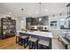 Modern kitchen with stainless steel appliances, a large island, and stylish pendant lighting at 3814 Zenobia St, Denver, CO 80212