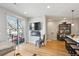 Open-concept living area with modern furnishings, a wall-mounted TV, and access to a balcony at 3814 Zenobia St, Denver, CO 80212