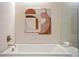 Modern bathroom featuring a soaking tub with stylish tile surround and contemporary art at 2518 N Washington St, Denver, CO 80205