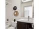 Bathroom with a modern vanity, a bathtub with shower, and neutral-toned decor at 2518 N Washington St, Denver, CO 80205