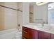 Bathroom with a modern vanity, a bathtub with shower, and neutral-toned decor at 2518 N Washington St, Denver, CO 80205