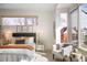 Cozy bedroom features natural light, neutral tones, plush bedding and a comfortable sitting area near large windows at 2518 N Washington St, Denver, CO 80205