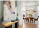 A dining room is adjacent to an open kitchen, with hardwood floors, modern art and large windows at 2518 N Washington St, Denver, CO 80205